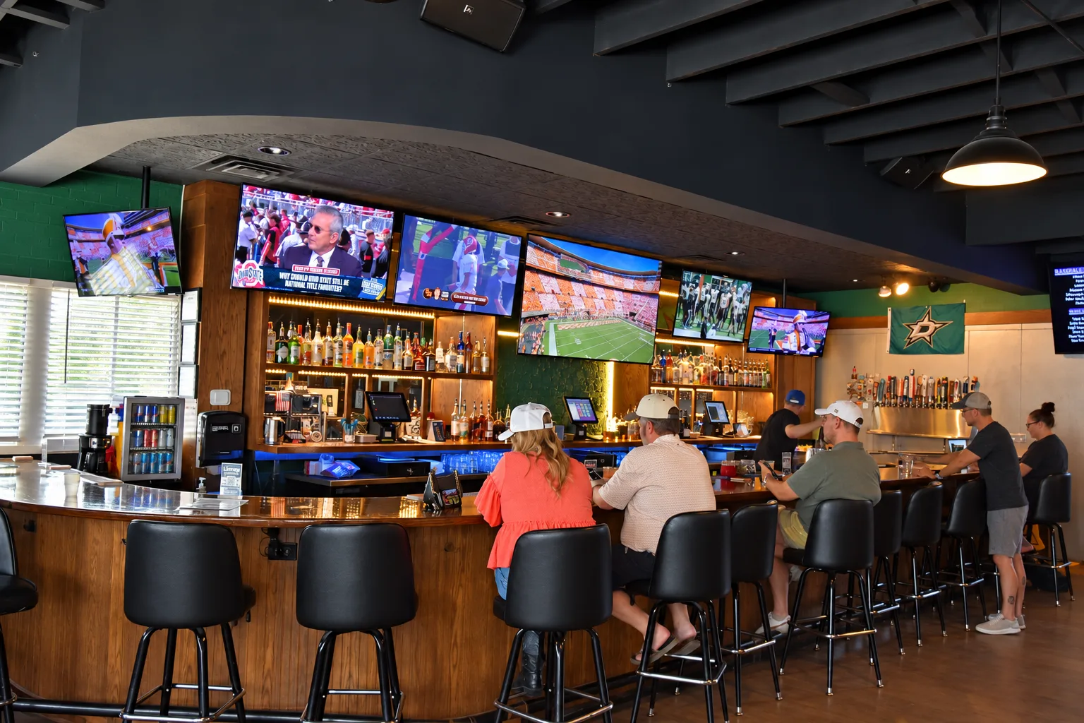 Guests at the bar watching games on the TVs inside Morton's Tavern sports bar in Fort Worth