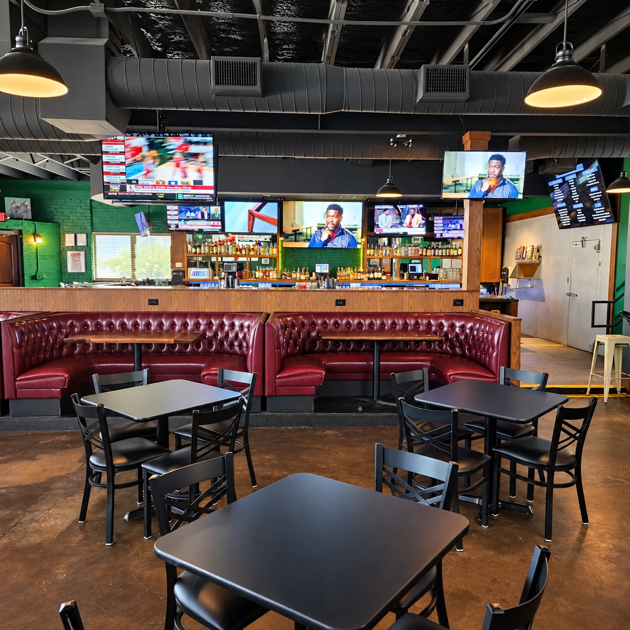 Red booths and TVs inside Morton's Tavern sports bar in Fort Worth